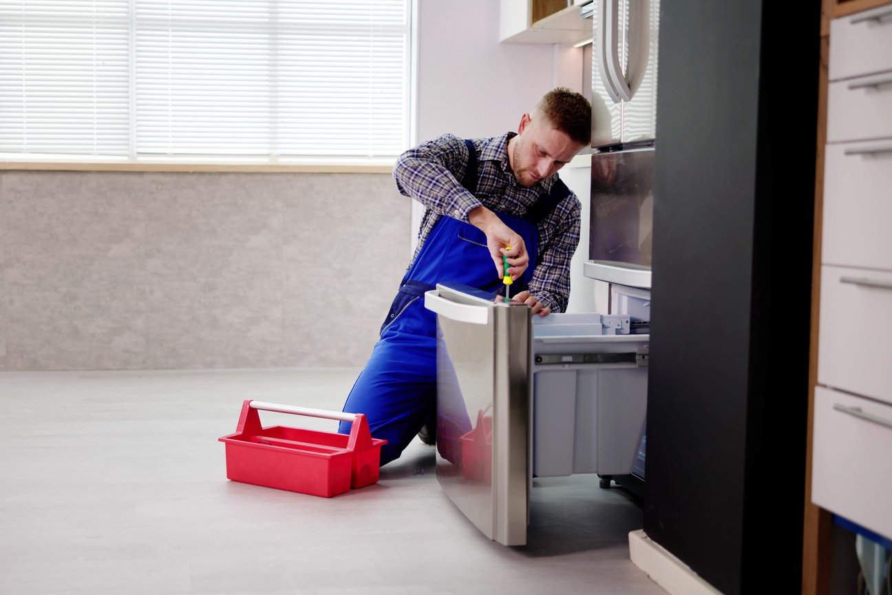 Electrician Technician Working To Repair Refrigerator